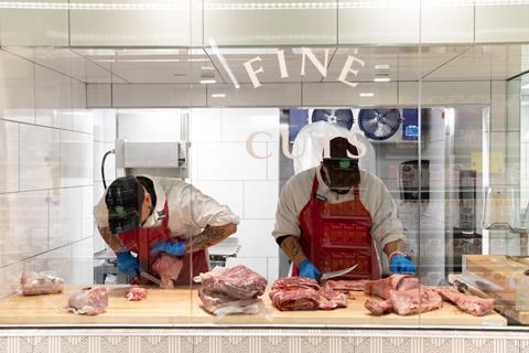 Two butchers working at Whole Foods Market, One Wall Street